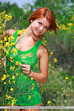 Amidst a bush of dainty flowers, redhead violla a playfully poses, showing off her luscious body and smooth assets