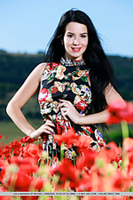 With her long black hair, striking smile, and smooth, fair skin, lola marrons beauty stands out as she sprawls naked in the middle of a flower field