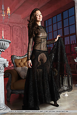 Wearing a sheer black lace dress and matching stockings, starlet is a ravishing temptress