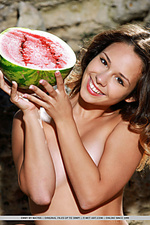 Emmy emmy playfully poses with a watermelon on her sweet body.