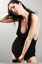 Alabaster-skinned vixen in thigh-high leather boots and black tank top.