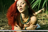 Lusty and erotic redhead in daring and arousing poses.