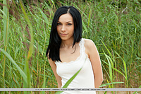With a confident, youthful allure, lily is a stunning sight as she strips her sexy white dress amidst the tall, verdant grass and sandy shore.