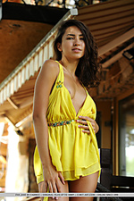 A bright yellow halter dress compliments eva jane