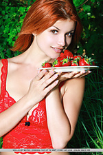 Naughty redhead violla a posing in her bright red lace lingerie and a plateful of red strawberries, her porcelain skin and wonderful assets stands out in her lush surroundings.