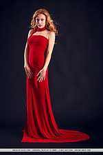 Wearing stylish red dress that hugs her body curves, her red hair elegantly cascading into curls, aislins exotically girlish beauty with womanly allure can make any man down to his knees.